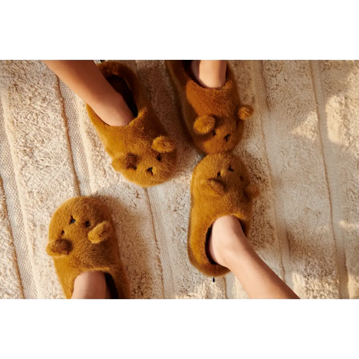 Liewood Canada fuzzy brown bear slippers worn by two children